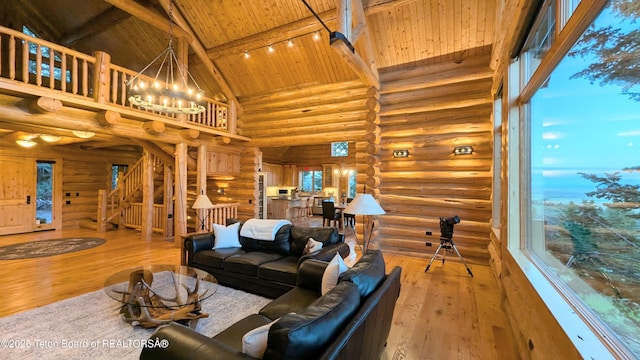 8157 Ripplinger Rd, Driggs, ID 83422 - living room featuring rustic walls, a wooden ceiling with exposed beams, high vaulted ceiling, wood-type flooring, and a chandelier