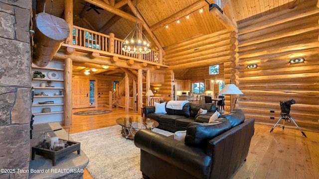 8157 Ripplinger Rd, Driggs, ID 83422 - living room featuring high vaulted ceiling, log walls, a wood ceiling with exposed beams, a chandelier, and hardwood / wood-style flooring