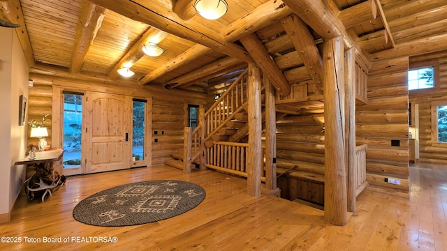 8157 Ripplinger Rd, Driggs, ID 83422 - foyer with log walls, a wood ceiling with exposed beams, stairs, and wood-type flooring