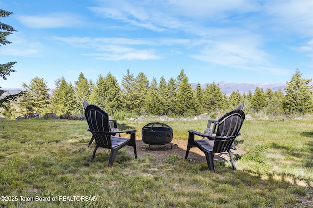 8157 Ripplinger Rd, Driggs, ID 83422 - view of yard featuring an outdoor fire pit and a mountain view