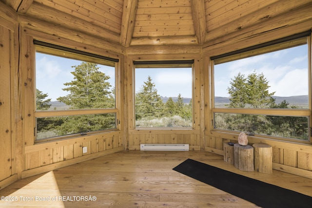 8157 Ripplinger Rd, Driggs, ID 83422 - unfurnished sunroom featuring baseboard heating, wood-type flooring, a mountain view, and wood ceiling