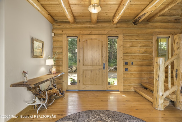8157 Ripplinger Rd, Driggs, ID 83422 - foyer entrance with a wooden ceiling with exposed beams, plenty of natural light, hardwood / wood-style floors, log walls, and stairway