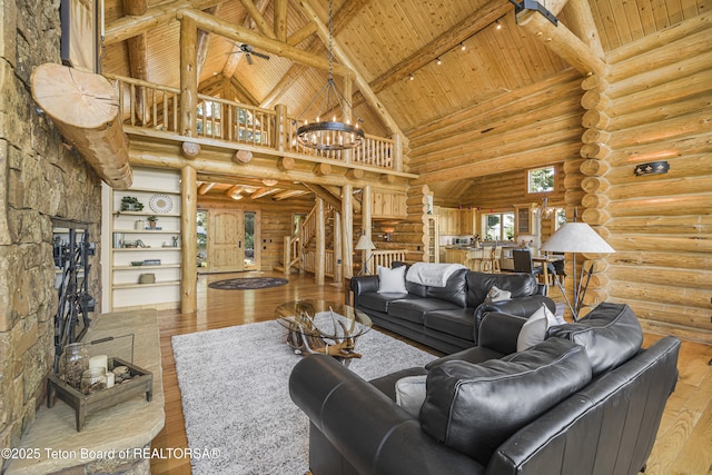 8157 Ripplinger Rd, Driggs, ID 83422 - living room featuring a wooden ceiling with exposed beams, high vaulted ceiling, hardwood / wood-style flooring, rustic walls, and a chandelier
