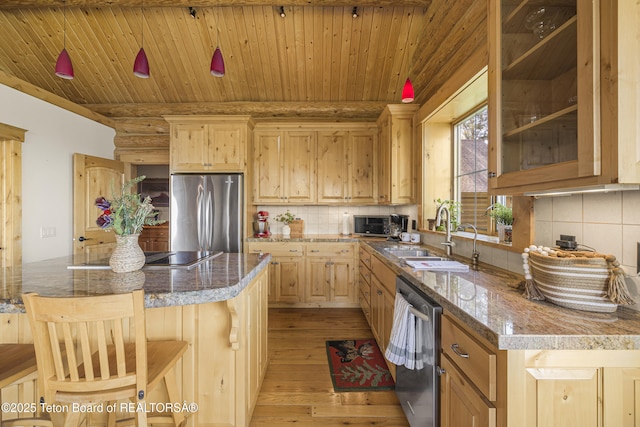8157 Ripplinger Rd, Driggs, ID 83422 - kitchen featuring appliances with stainless steel finishes, light brown cabinetry, light wood-style floors, backsplash, and wooden ceiling