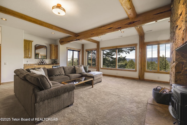 8157 Ripplinger Rd, Driggs, ID 83422 - living area featuring beamed ceiling, light colored carpet, recessed lighting, and a wood stove