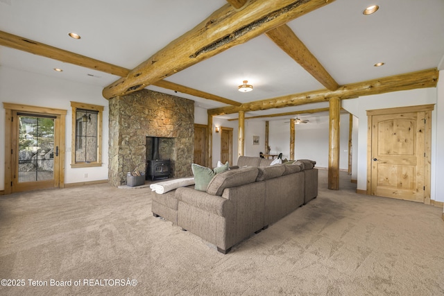 8157 Ripplinger Rd, Driggs, ID 83422 - living room featuring carpet floors, a wood stove, beam ceiling, and recessed lighting