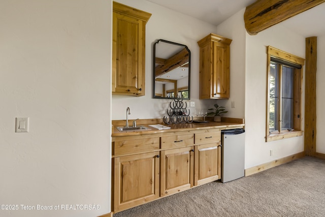 8157 Ripplinger Rd, Driggs, ID 83422 - kitchen featuring fridge, beamed ceiling, and light colored carpet