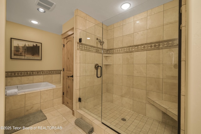 8157 Ripplinger Rd, Driggs, ID 83422 - bathroom featuring a shower stall, tile patterned floors, a garden tub, and recessed lighting