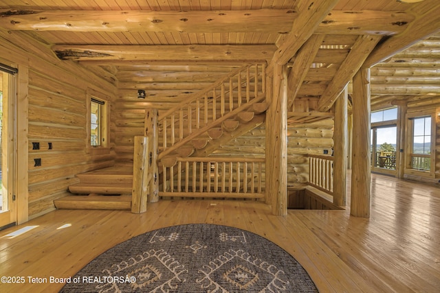 8157 Ripplinger Rd, Driggs, ID 83422 - stairway featuring rustic walls, hardwood / wood-style flooring, plenty of natural light, and a wooden ceiling with exposed beams