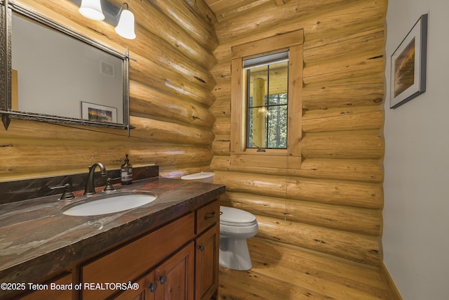 8157 Ripplinger Rd, Driggs, ID 83422 - bathroom featuring vanity, hardwood / wood-style floors, and log walls