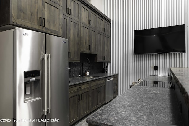 42 Airport Rd, Afton, WY 83110 - kitchen featuring stainless steel appliances, dark stone countertops, and dark brown cabinetry