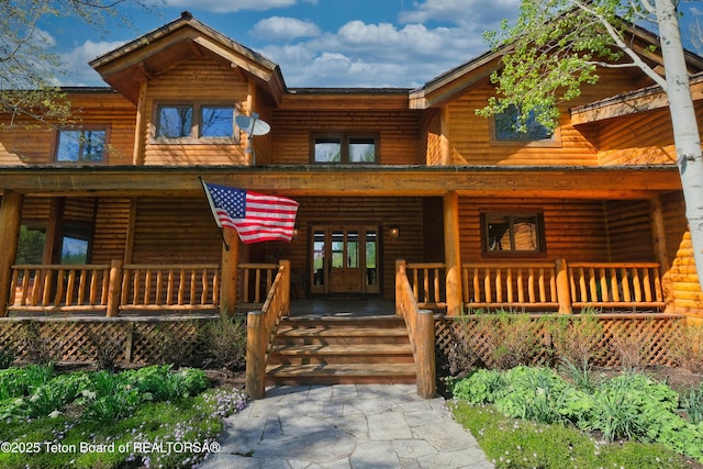 590 S Sandhill Crane Rd, Wilson, WY 83014 - log home with a porch, faux log siding, and french doors