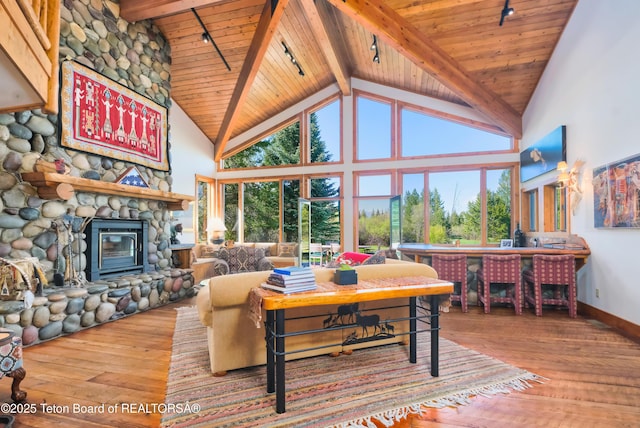 590 S Sandhill Crane Rd, Wilson, WY 83014 - living area featuring a wood ceiling with exposed beams, hardwood / wood-style flooring, track lighting, high vaulted ceiling, and a fireplace