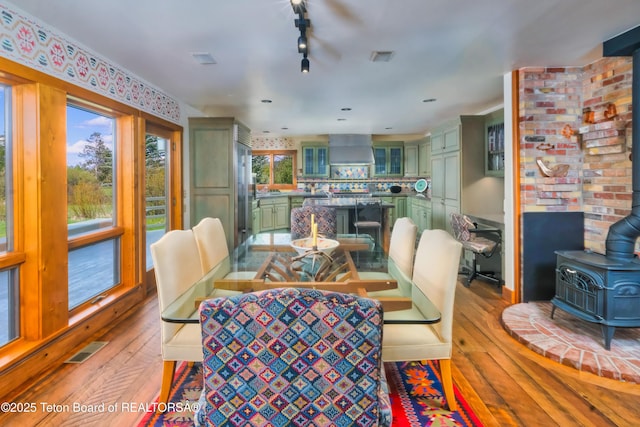 590 S Sandhill Crane Rd, Wilson, WY 83014 - dining room with a wood stove and light wood-type flooring