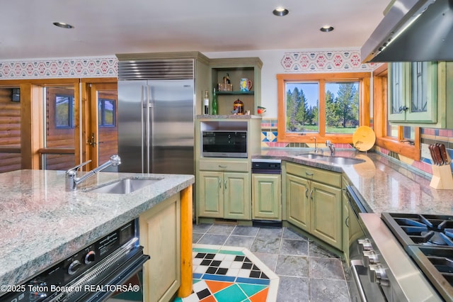 590 S Sandhill Crane Rd, Wilson, WY 83014 - kitchen with appliances with stainless steel finishes, extractor fan, green cabinets, light stone counters, and open shelves