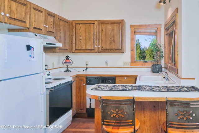 590 S Sandhill Crane Rd, Wilson, WY 83014 - kitchen featuring white appliances, brown cabinetry, and light countertops