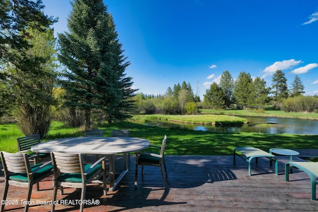 590 S Sandhill Crane Rd, Wilson, WY 83014 - wooden terrace with a water view, outdoor dining space, and a yard