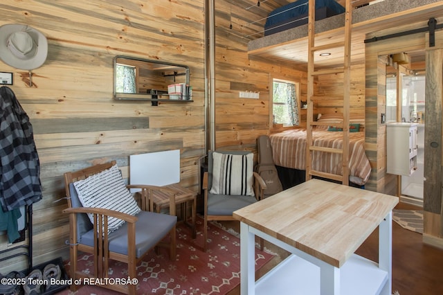 66 Elkhorn Dr, Thayne, WY 83127 - bedroom with wood walls and a barn door