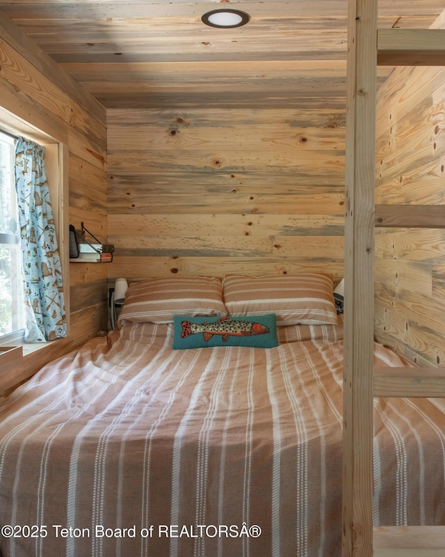 66 Elkhorn Dr, Thayne, WY 83127 - unfurnished bedroom featuring wooden walls and multiple windows