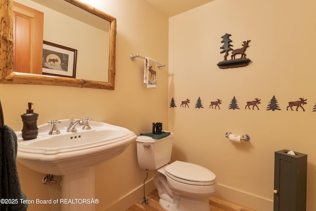 6790 N Timothy Rd, Jackson, WY 83001 - half bath featuring baseboards and wood finished floors