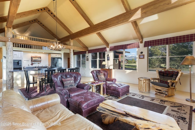 6790 N Timothy Rd, Jackson, WY 83001 - living area featuring a chandelier, high vaulted ceiling, beam ceiling, and wood finished floors