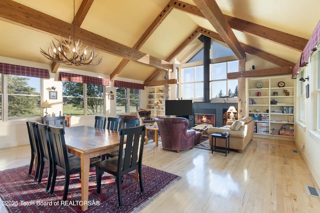 6790 N Timothy Rd, Jackson, WY 83001 - dining room with wood finished floors, a chandelier, beamed ceiling, and high vaulted ceiling