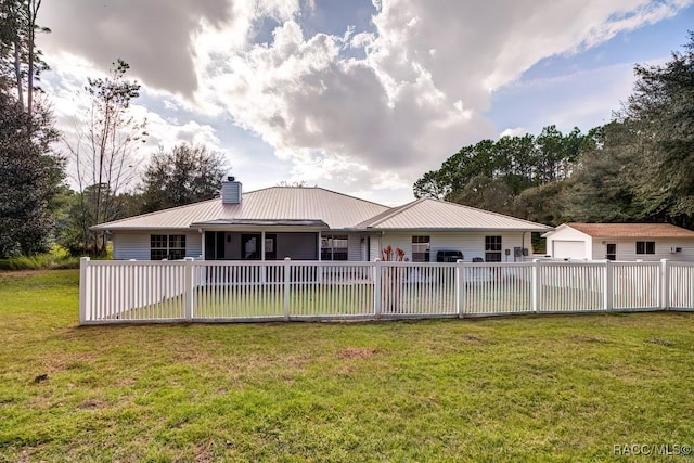 2195 W Huntington Dr, Beverly Hills, FL 34465 - back of house featuring a chimney, an outdoor structure, a metal roof, and a detached garage