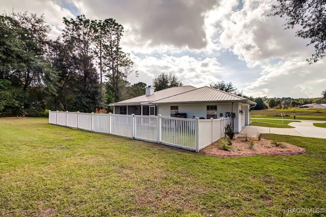 2195 W Huntington Dr, Beverly Hills, FL 34465 - rear view of house with a garage, concrete driveway, a chimney, and a metal roof