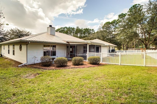 2195 W Huntington Dr, Beverly Hills, FL 34465 - back of house featuring a chimney, a metal roof, and a sunroom