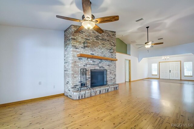 2195 W Huntington Dr, Beverly Hills, FL 34465 - unfurnished living room featuring ceiling fan, high vaulted ceiling, wood finished floors, and a brick fireplace