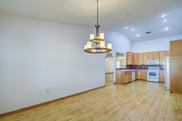 2195 W Huntington Dr, Beverly Hills, FL 34465 - kitchen with white appliances, arched walkways, tasteful backsplash, open shelves, and light wood-style flooring