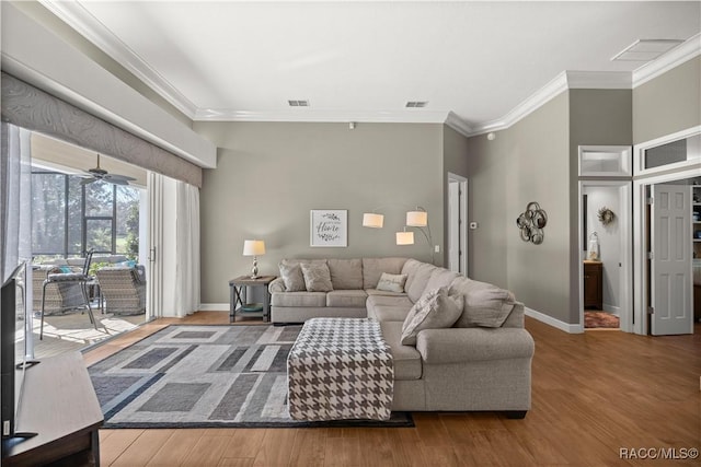 living room featuring crown molding, ceiling fan, and hardwood / wood-style floors