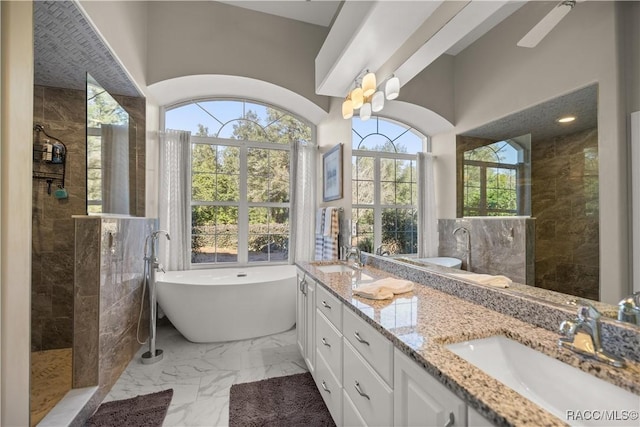 bathroom featuring vanity and independent shower and bath