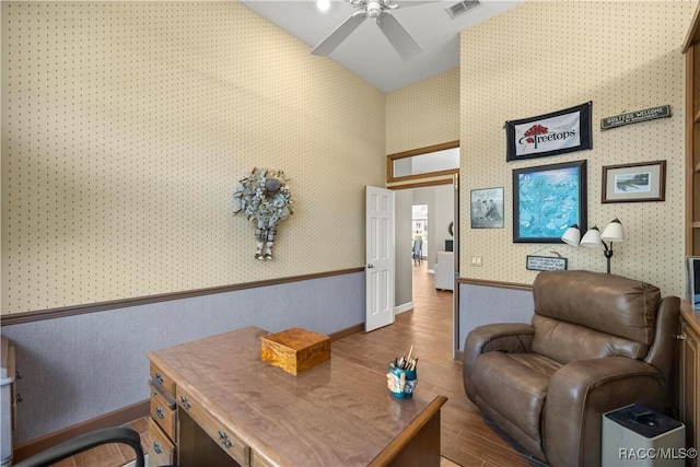 home office with lofted ceiling, dark hardwood / wood-style floors, and ceiling fan