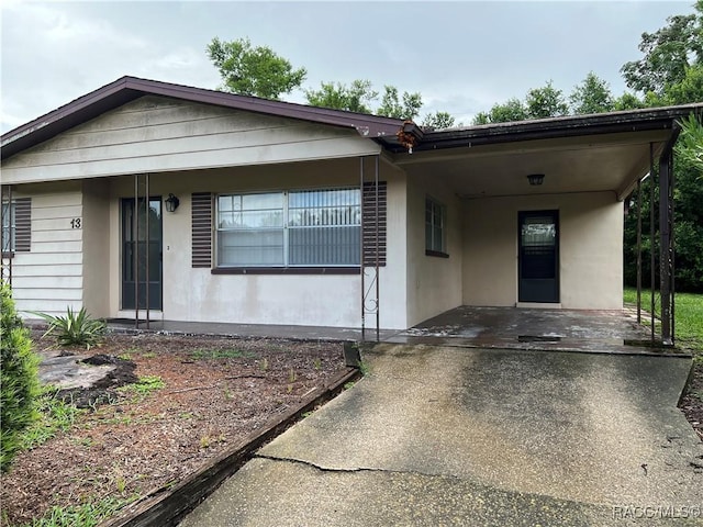13 N Wadsworth Ave, Beverly Hills, FL 34465 - view of front of home with a carport and driveway