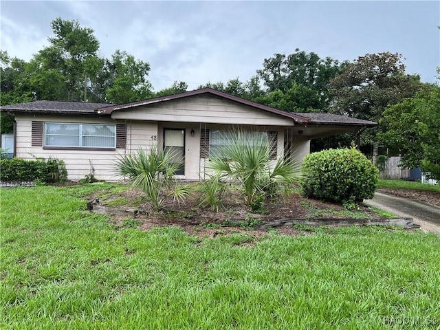 13 N Wadsworth Ave, Beverly Hills, FL 34465 - view of front facade with a front lawn and an attached carport