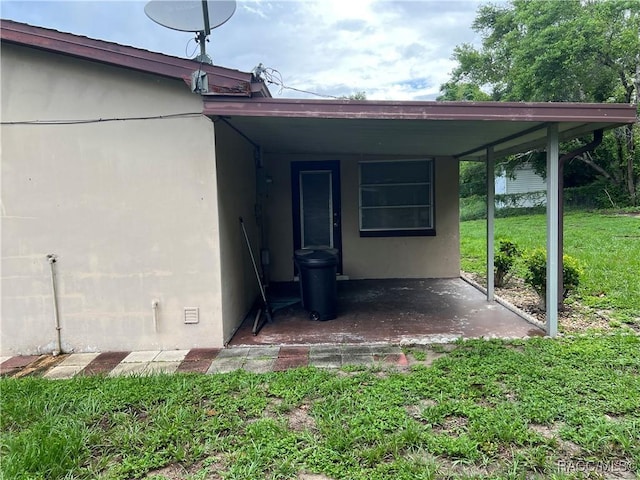 13 N Wadsworth Ave, Beverly Hills, FL 34465 - property entrance with a yard and stucco siding