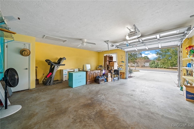 garage with a garage door opener and ceiling fan