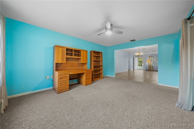 home office featuring ceiling fan with notable chandelier and carpet floors