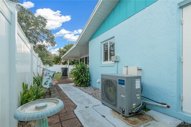 view of property exterior with a patio area and ac unit