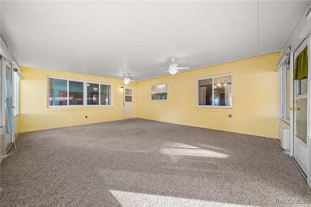 spare room with carpet, ceiling fan, and radiator heating unit