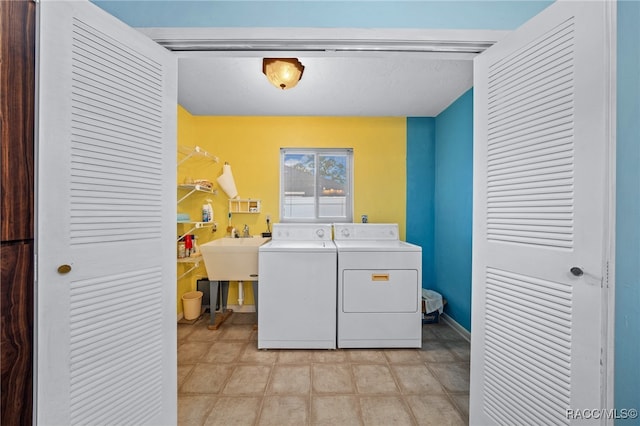 laundry area with washer and dryer and sink