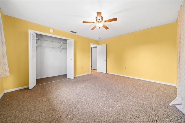 unfurnished bedroom featuring ceiling fan, a closet, and carpet floors