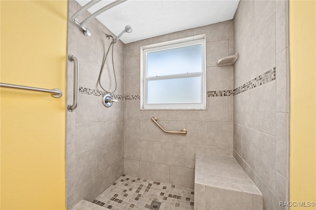 bathroom with tiled shower