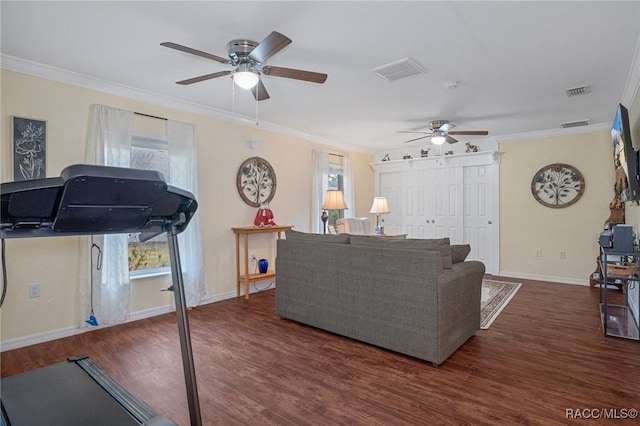 living room featuring a healthy amount of sunlight, crown molding, and dark wood-type flooring