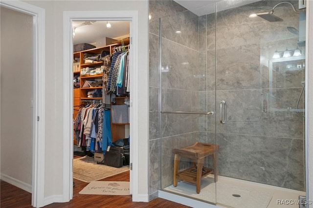 bathroom featuring wood-type flooring and a shower with shower door