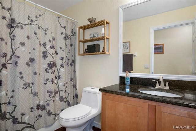 bathroom with vanity, toilet, and curtained shower