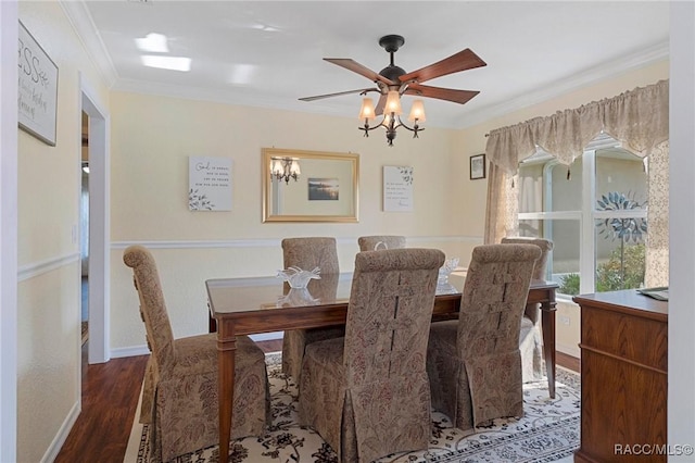 dining room with dark hardwood / wood-style floors, crown molding, and ceiling fan with notable chandelier