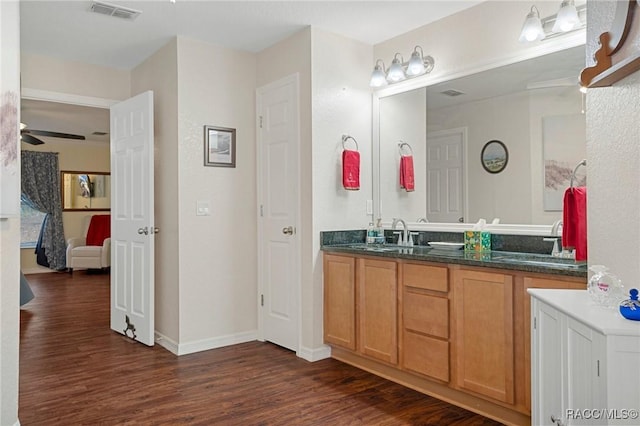 bathroom featuring wood-type flooring, vanity, and ceiling fan