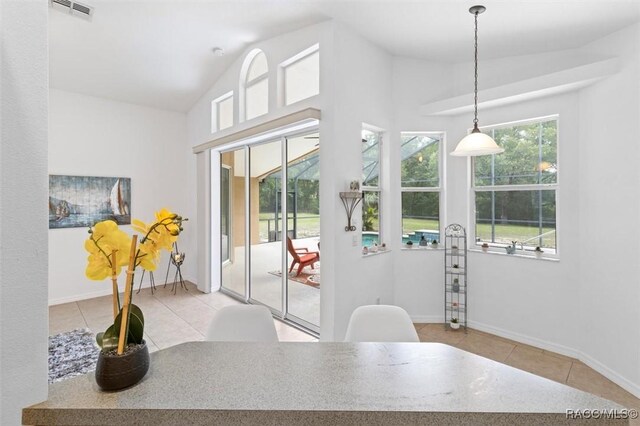 8583 N Tibet Ter, Dunnellon, FL 34433 - tiled dining area with lofted ceiling and baseboards